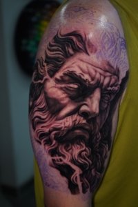 black and grey tattoo on biceps