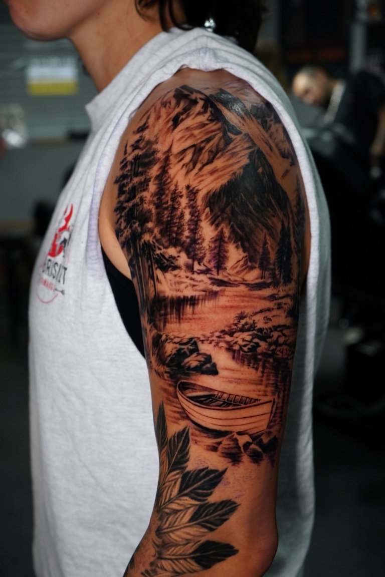 black and grey tattoo on left sleeve