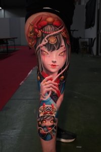 full leg evil doll tattoo style