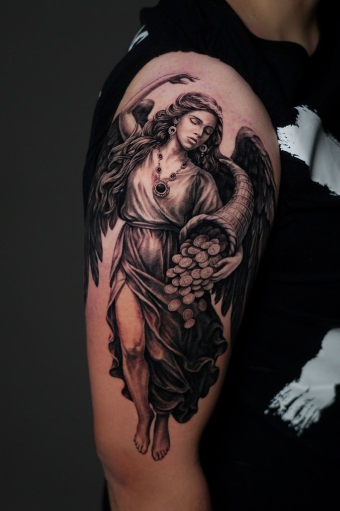 angel tattoo on right arm