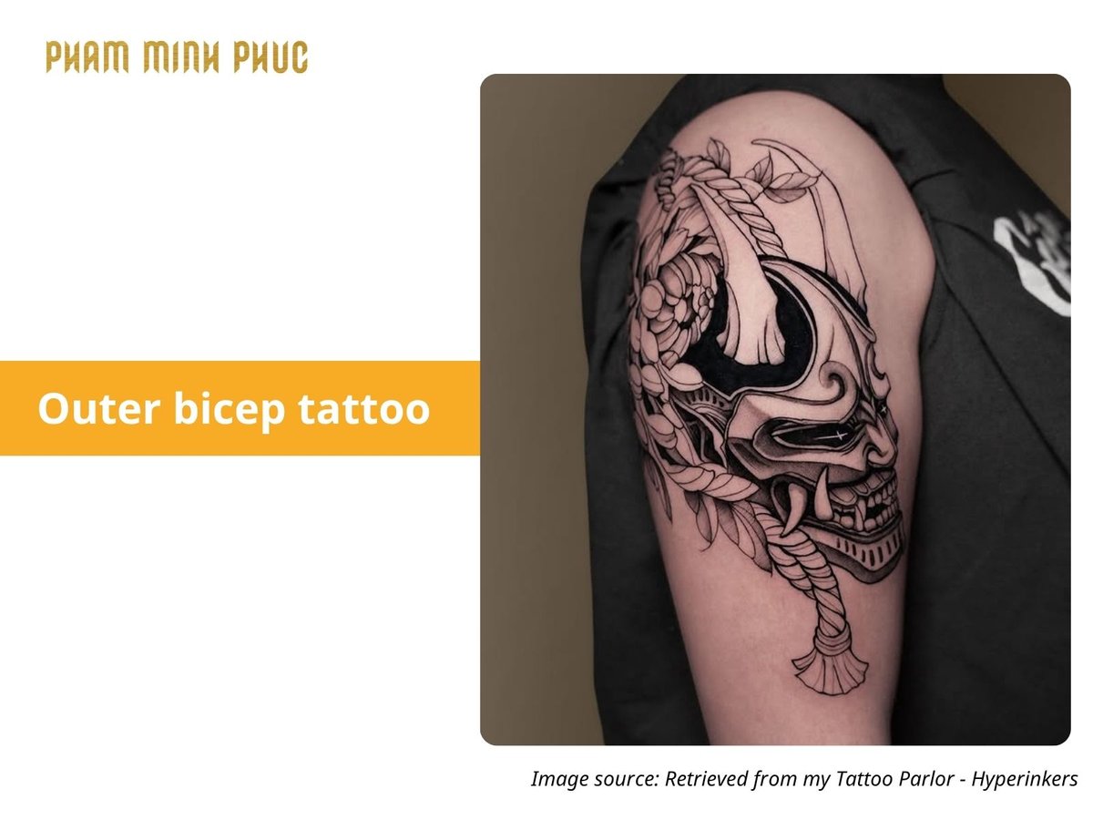 black and grey outer bicep tattoo