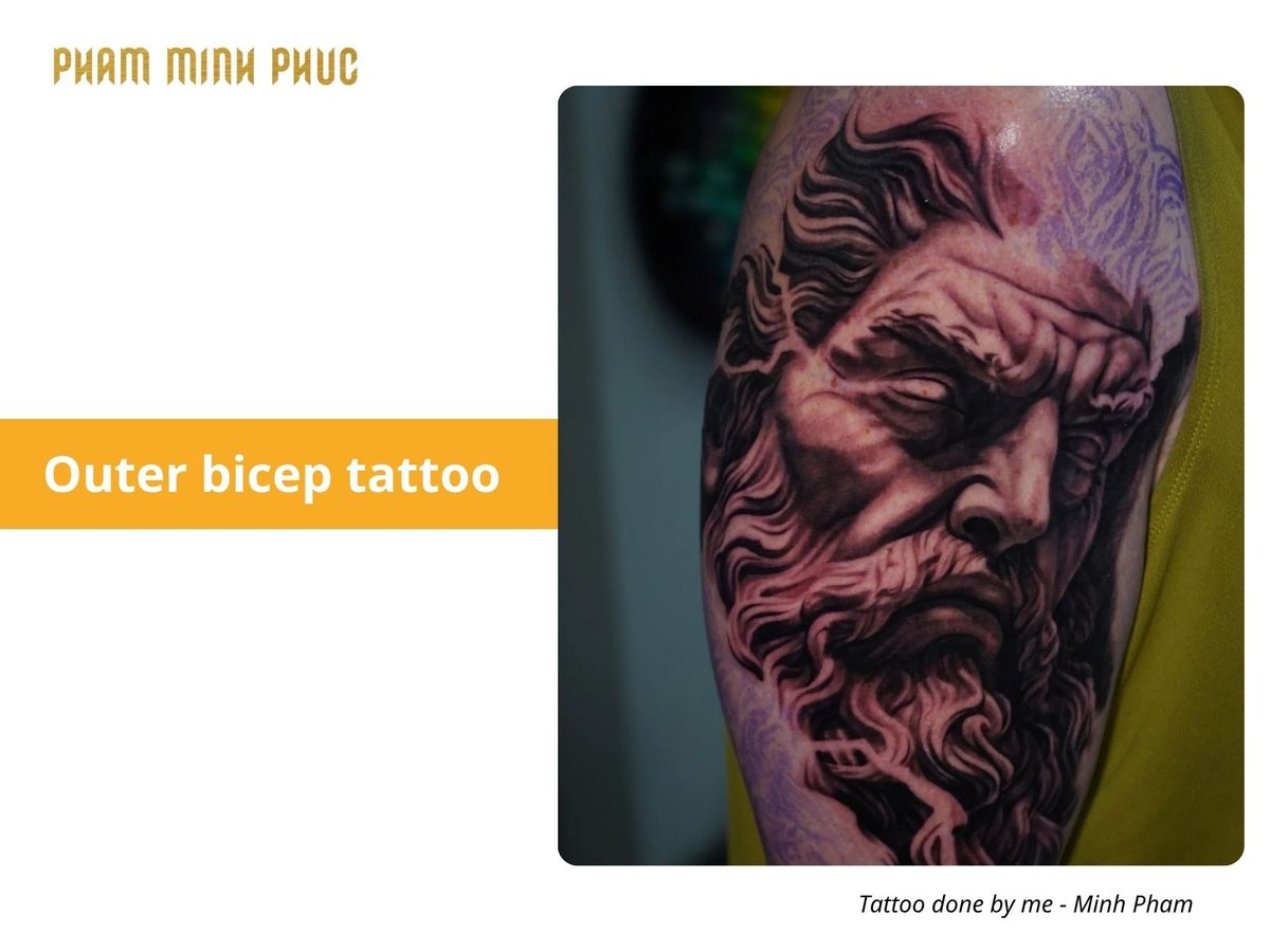 black and grey portrait outer bicep tattoo