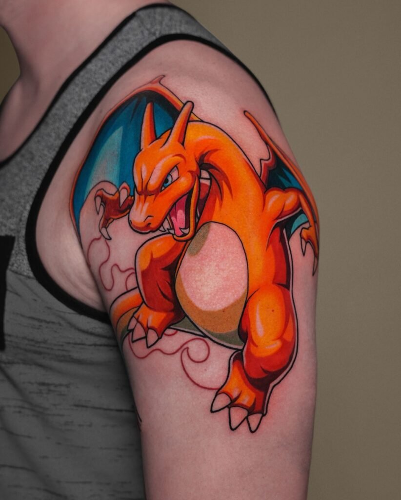 Anime color tattoo of Charizard from Pokémon on the shoulder, starting an arm sleeve