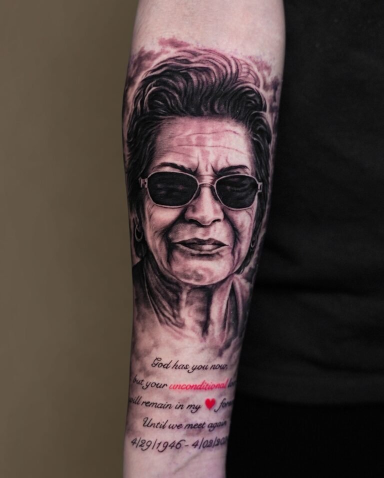 Black and grey realism portrait tattoo of a grandmother in sunglasses with a memorial quote on the forearm